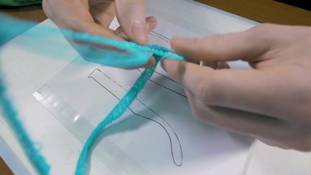 Man shows glasses just made with 3D printing pen. 4K.