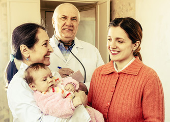   doctors talks to young mother of  baby