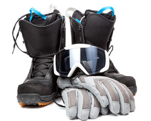 Snowboard boots with mask and gloves on white background