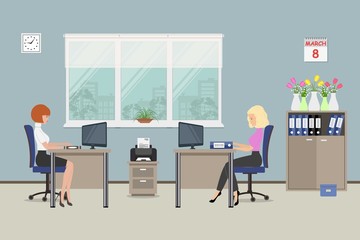 Office room on the day of March 8. The young women are employees at work. There is beige furniture on a window background in the picture. There are also vases with flowers on the cabinet. 