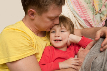 the father embraces the little son and cheerfully spend time. Fa