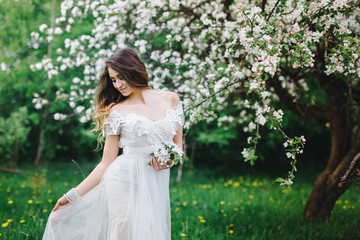 portrait of a beautiful girl in the apple orchard