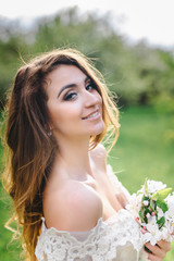 Obraz premium portrait of a beautiful girl in the apple orchard
