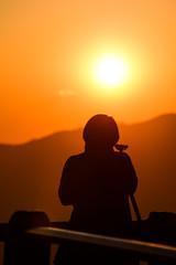 Fototapeta na wymiar Silhouette of photographer, taking pictures of the beautiful moments during the sunset ,sunrise.