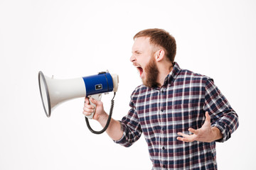 Bearded man in shirt screaming at megaphone