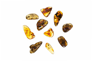 Ten yellow amber stones close-up on a white background.