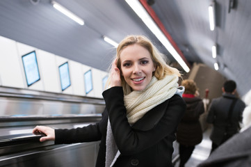 Young woman standing at the escalator in Vienna subway