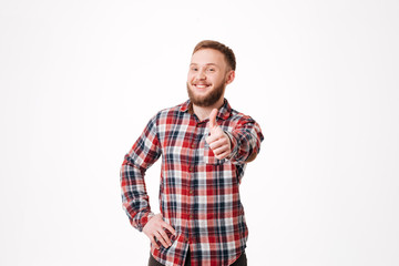 Smiling Bearded man in shirt showing thumb up