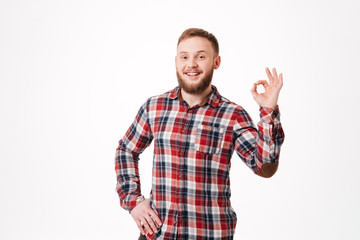 Fototapeta premium Smiling Bearded man in shirt showing ok sign