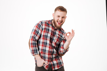 Happy Bearded man in shirt showing ok sign
