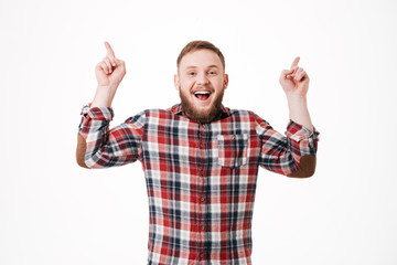 Laughing Bearded man in shirt pointing up