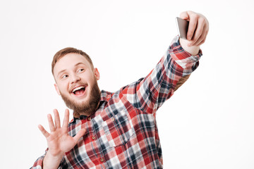 Naklejka premium Bearded man in shirt making selfie