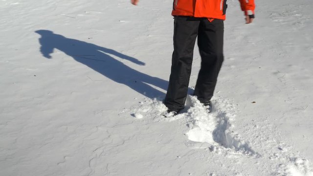 Young man throwing himself in the snow and making snow angels