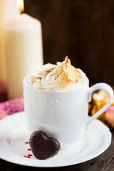 Hot Tea or Chocolate in White Cups with Chocolate Hearts and Lit Candles on Wooden Rustic Background, Valentines Day Concept