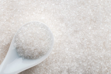 White sugar in ceramic spoon