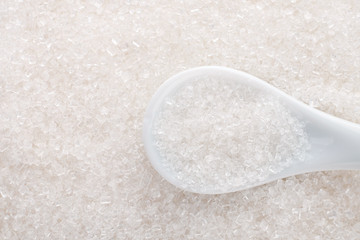 White sugar in ceramic spoon
