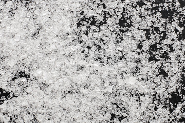 White sugar on a black background, top view.