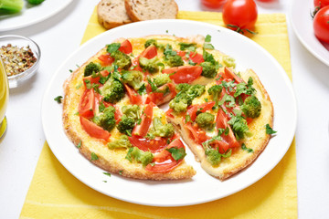 Omelet with broccoli, tomato, onion, parsley