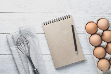 Eggs and ingredients for baking on a light wooden table. Top vie