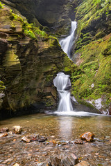 Fototapeta premium St Nectans Kieve waterfall in St Nectan's Glen valley in North Cornwall