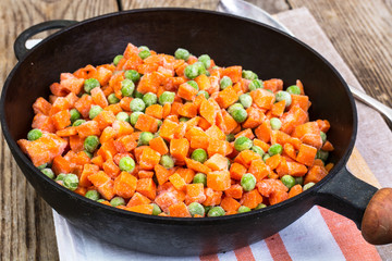 Frozen peas and carrots for cooking on a pan