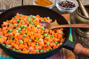 Frozen peas and carrots for cooking on a pan