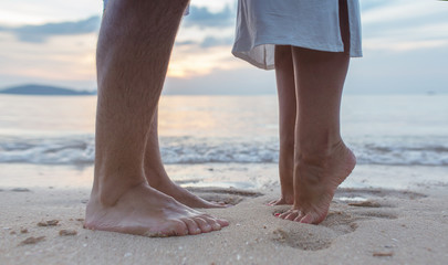 couple legs on the sand beach of Thailand