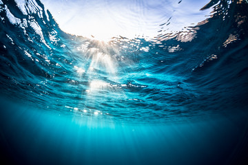 Underwater shot of the sea surface with sunny beams and waves