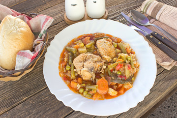 Chicken meat stew with vegetables and rice in plate