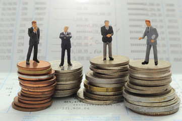 Business people over money background ,miniature people concept.