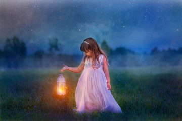 Fairytale portrait of Little girl with lightning at the night field