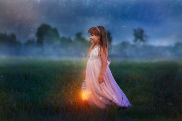 Fairytale portrait of Little girl with lightning at the night field