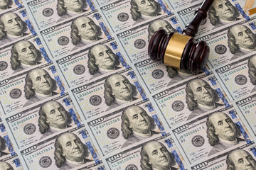 Us Money with judges hammer on wooden table, top view.