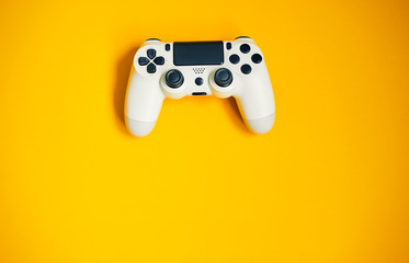 Computer game competition. Gaming concept. White joystick on yellow background. © luengo_ua