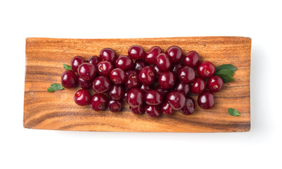 ripe cherries and leaves in a square wooden plate isolated on a white background