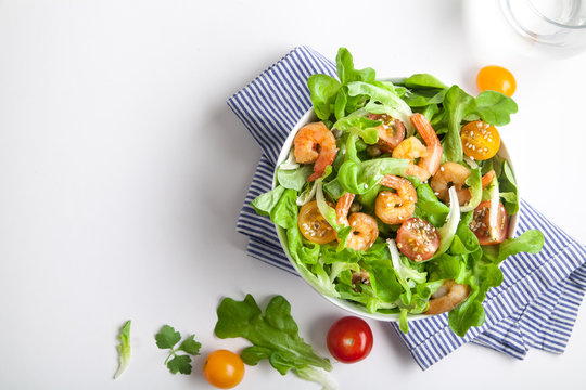 Shrimp salad with cherry tomatoes in bowl. Top view, copy space