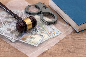 us Money with wooden hammer handcuffs, law  book
