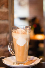 Coffe with whiped cream for breakfast with croissant in cafe