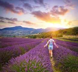Beautiful young woman in summer day in lavender field