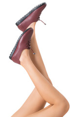 Woman beautiful long legs healthy skin stretching her legs pose and wearing vintage fashion leather shoes, Isolated on white background.