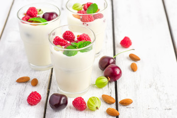 Homemade yoghurt with summer berries and almonds, selective focu