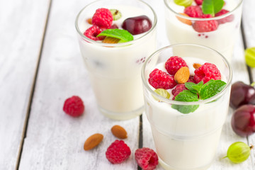 Homemade yoghurt with summer berries and almonds, selective focu