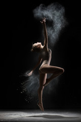 Female gymnast dances in cloud of white powder