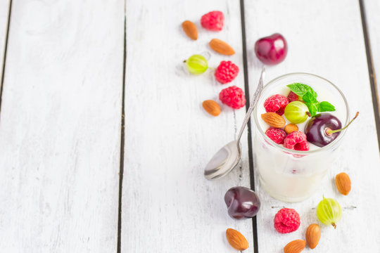 Homemade yoghurt with summer berries and almonds, selective focu