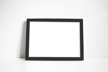 Black landscape frame against white wall