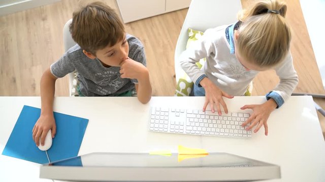 Kids in computer lab working on desktop computer