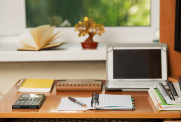 Office desk table with computer, calculator, supplies. Copy space for text