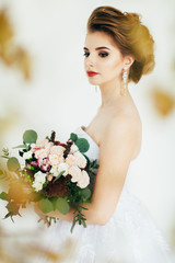Portrait of bride with bouquet in Studio