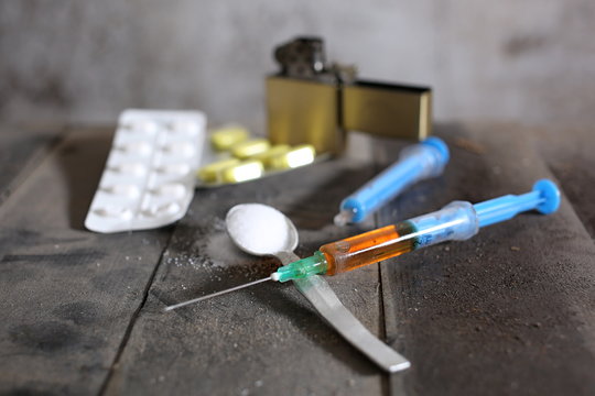 Hard drugs on dark table. A dark theme, drug use.