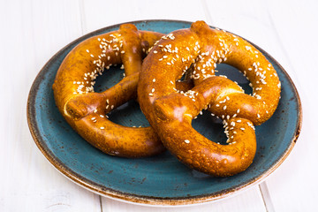 Bavarian pretzels with sesame seeds on white boards